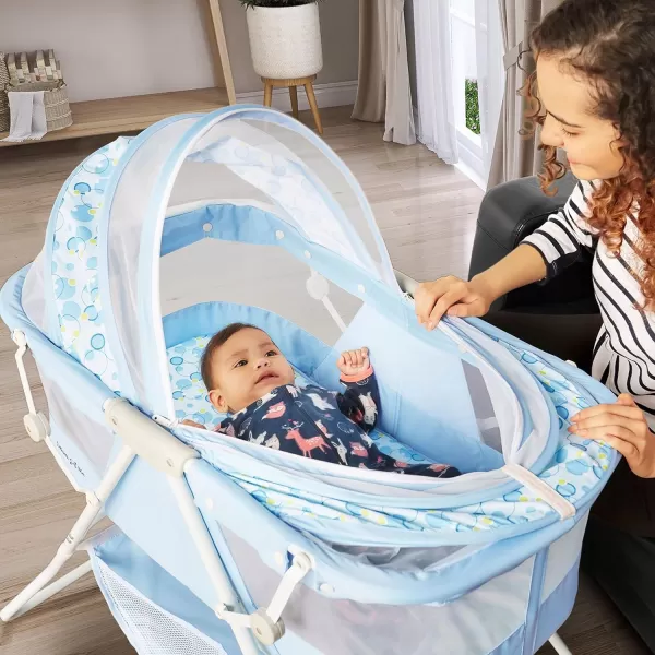 Karley Bassinet in Cool Grey, Lightweight Portable Baby Bassinet, Quick Fold and Easy to Carry , Adjustable Double Canopy, Indoor and Outdoor Bassinet with Large Storage Basket.