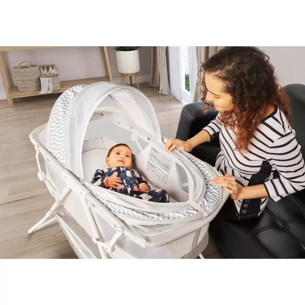 Karley Bassinet in Cool Grey, Lightweight Portable Baby Bassinet, Quick Fold and Easy to Carry , Adjustable Double Canopy, Indoor and Outdoor Bassinet with Large Storage Basket.