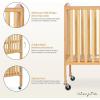 imageDream On Me Folding Full Size Convenience Crib In Storm Grey Two Adjustable Mattress Height Positions Comes With Heavy Duty Locking Wheels Flat FoldingNatural